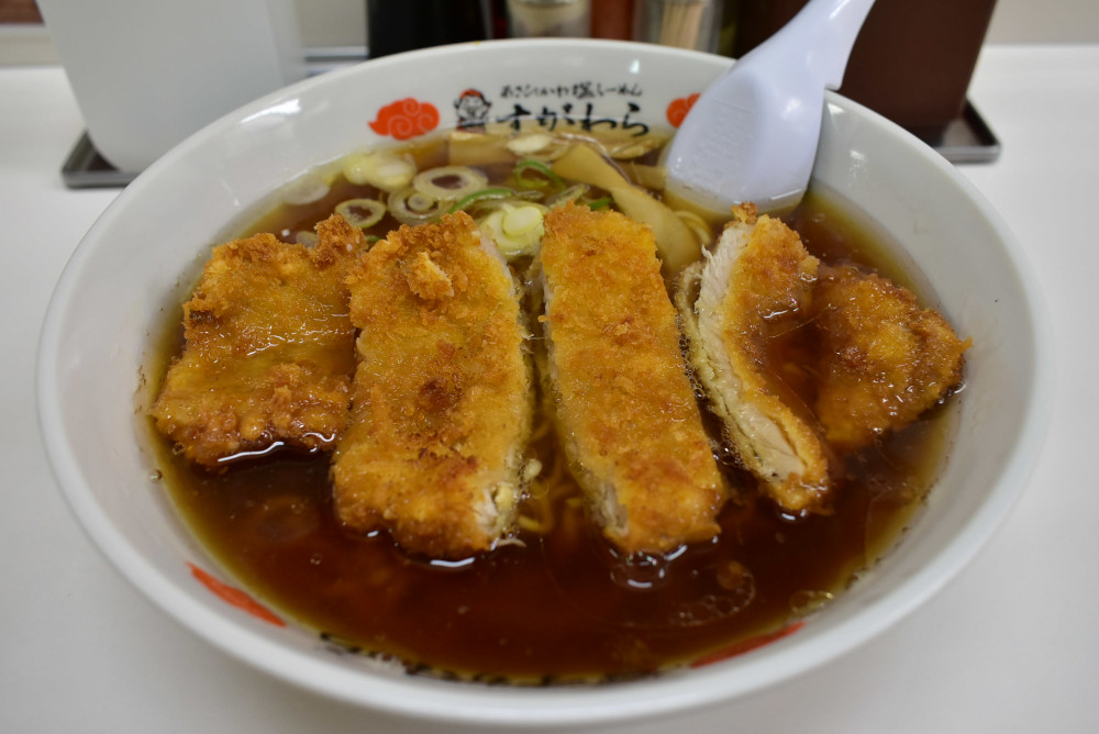 澄んだ醤油スープに中細麵のラーメン、カリッと揚がったトンカツが大胆にのっている。「カツラーメン 醤油」1,150円(税込み)