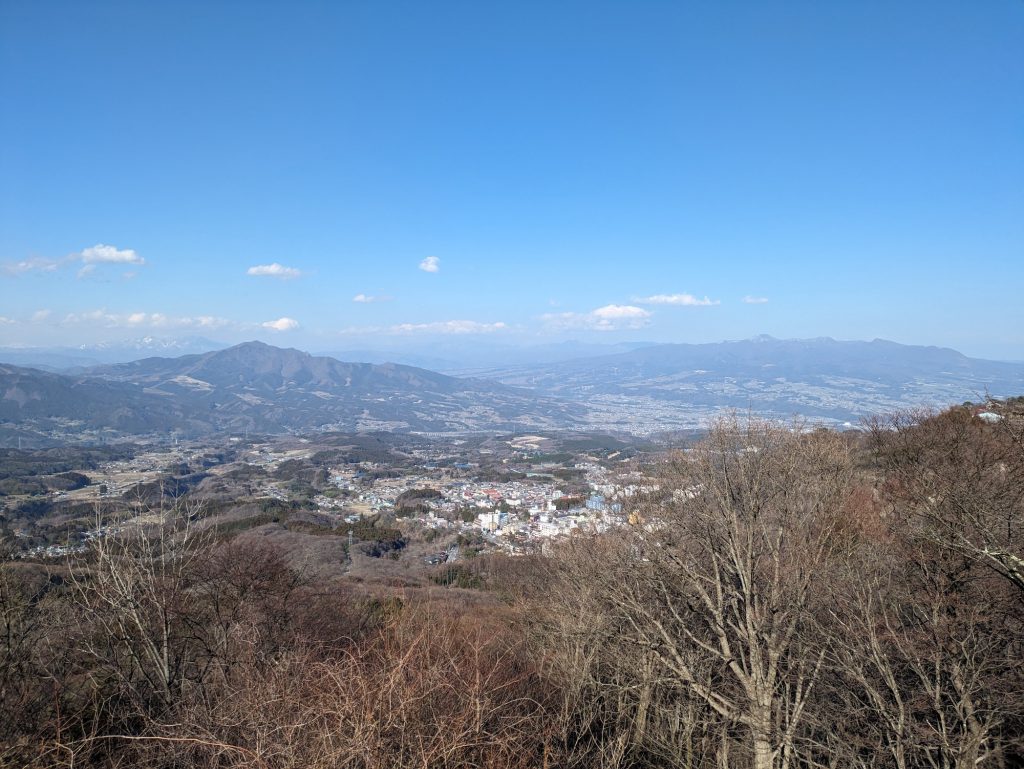 正面右手に見えるなだらかな山が上毛三山の一角・赤城山。直下に見える街並みが伊香保温泉街だ